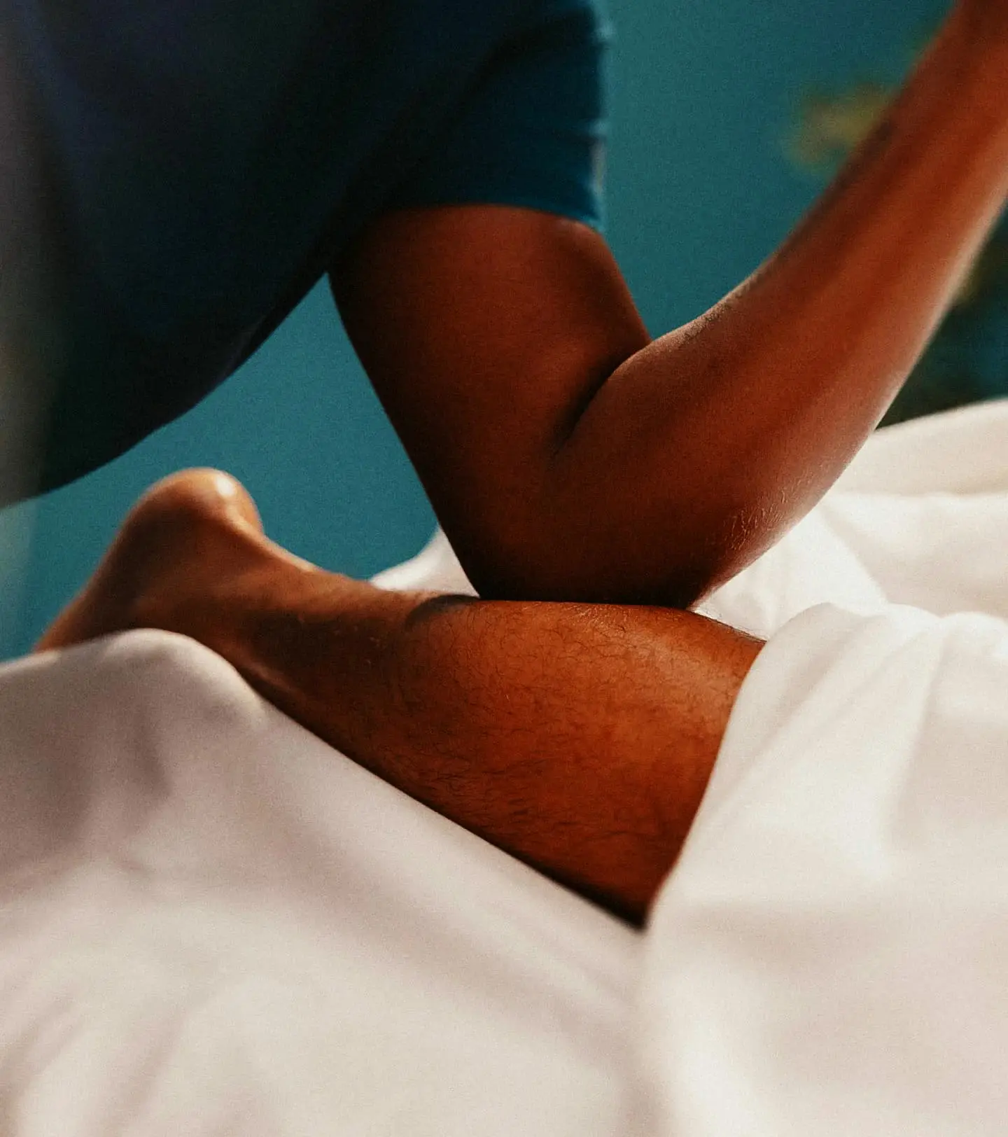 A therapist applying firm forearm pressure during a deep tissue massage